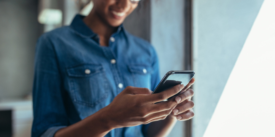 MAIN-woman-using-mobile-phone-960x480